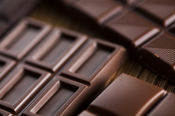 Chocolate bar, candy sweet, dessert food on wooden background