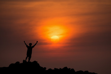 silhouette man Happy celebrating winning success at sunset
