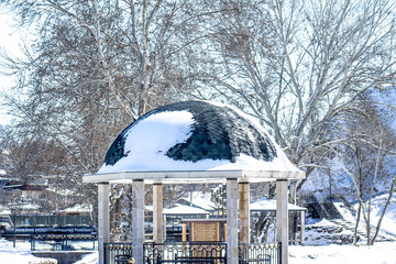 a gazebo in a park in the snow