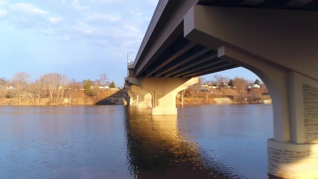 Unique aerial view of bridge from below, with amazing sunrise light. Stunning scenic with unique perspective. 