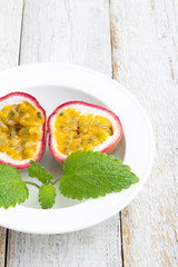 passion fruit and mint on a white plate.