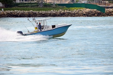 Obraz premium Two fishermen heading back from the sea after a morning of sport fishing in southeast florida
