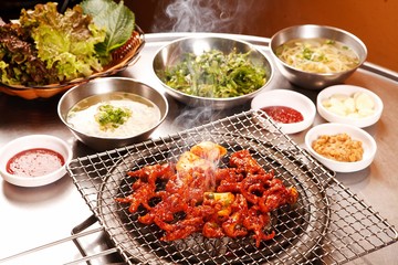 Spicy chicken feet on grill	