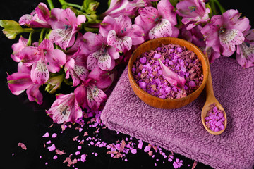 Obraz na płótnie Canvas Spa background-towel, orchid, and spoon ,petals in bowl, salt in spoon