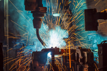Worker,welding in a car factory with sparks, manufacturing, industry

