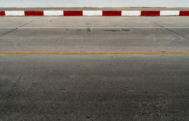 Red and white concrete road curb