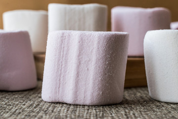 Stack of Marshmallows on wooden surface.
