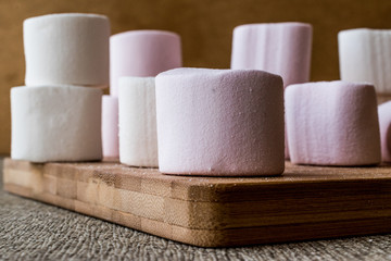 Stack of Marshmallows on wooden surface.