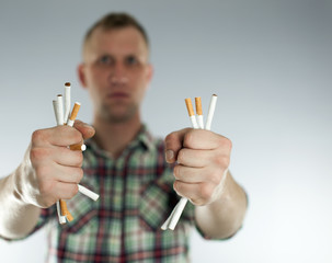 

Man trying to quit smoking. No to addictions! Conceptual image. 
