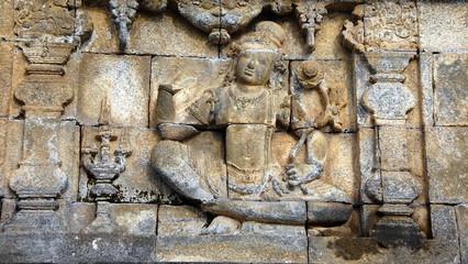 Ancient stone carvings are around Borobudur site. Borobudur, or Barabudur, is a 9th-century Mahayana Buddhist Temple in Magelang, Central Java, Indonesia