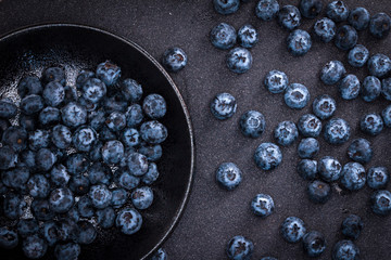  fresh picked blueberries on black stone background