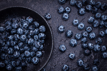  fresh picked blueberries on black stone background