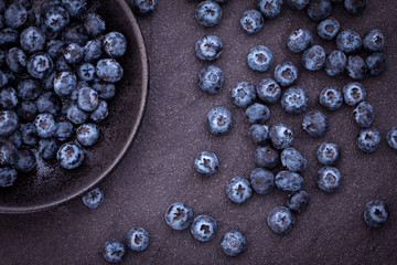  fresh picked blueberries on black stone background