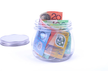 Saving Australian dollars in a glass jar