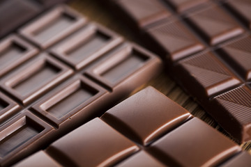 Chocolate bar, candy sweet, dessert food on wooden background