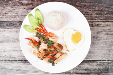 Jasmine rice topped stir - fried spicy basil with meat.
