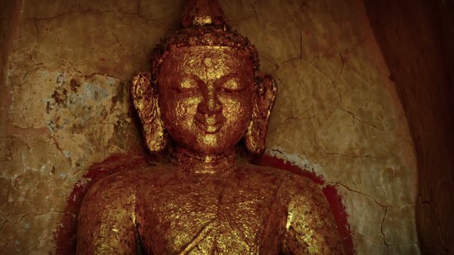 Ancient Buddha Statue Covered in Gold Leaf
