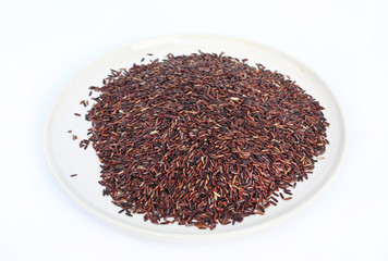 Jasmine red rice in plate on white background.