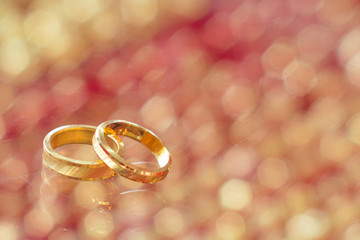 Gold ring couple with blurry background under mirror for love marriage