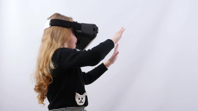 Side view Girls in virtual reality glasses stretching hands for protection.
