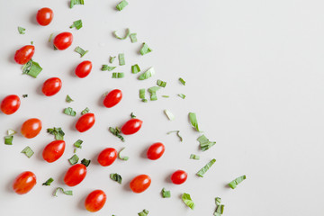 Background vegetables - tomato and greens on white, flat top view