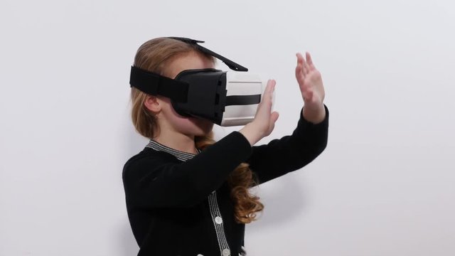 A girl with virtual reality glasses turns away from the threat.The imaginary danger in the virtual game.