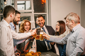 Group of friends enjoying evening drinks with beer