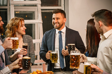Group of friends enjoying evening drinks with beer