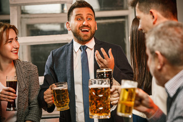Group of friends enjoying evening drinks with beer