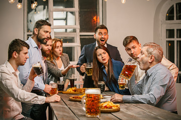 Group of friends enjoying evening drinks with beer