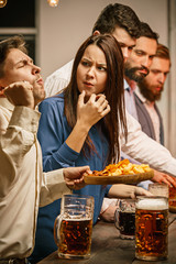 Group of friends enjoying evening drinks with beer