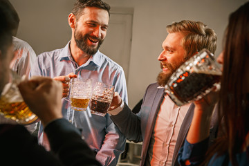 Group of friends enjoying evening drinks with beer