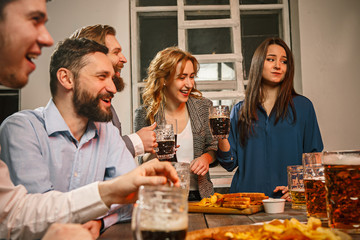 Group of friends enjoying evening drinks with beer