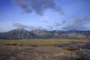 High Sierras - Early morning clouds rolling over snowy sierra mountains.