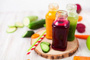 Freshly squeezed vegetable juice in bottles, useful vitamin cocktail, detox diet, selective focus