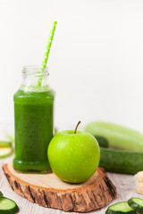 Green Healthy smoothie and apple on white background