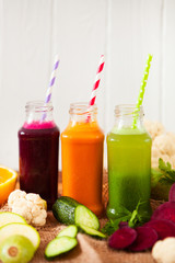 Freshly squeezed vegetable juice in bottles, useful vitamin cocktail, detox diet, selective focus