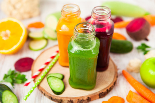 Freshly squeezed vegetable juice in bottles, useful vitamin cocktail, detox diet, selective focus