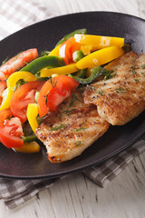 Grilled fish steaks and fresh vegetable salad close-up. vertical