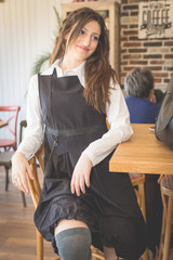 Young woman in restaurant talkin on the phone