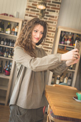 Young woman in restaurant talkin on the phone