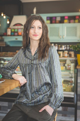 Young woman in restaurant talkin on the phone