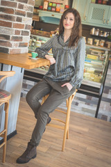 Young woman in restaurant talkin on the phone