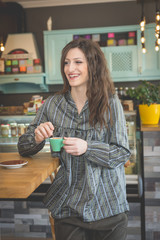 Young woman in restaurant talkin on the phone