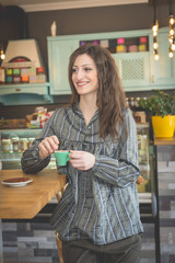 Young woman in restaurant talkin on the phone