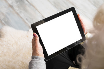 Senior holding blank screen tablet