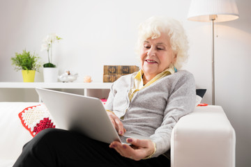 Elderly woman using laptop computer