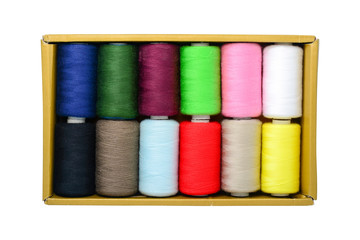 Spools of thread in box isolated on white