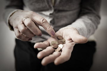 Older person counting money in her palm
