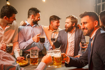 Group of friends enjoying evening drinks with beer